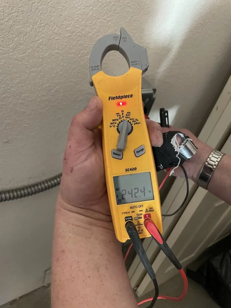 Voltage testing with clamp meter during Outlet Installation in Ste. Genevieve